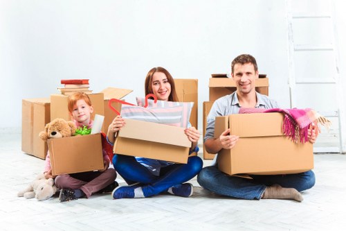 Removal team handling furniture and boxes in Alperton
