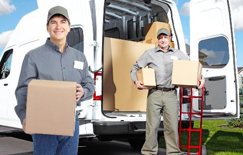 Local movers organising labelled boxes in Alperton property
