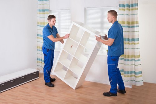 Local movers handling furniture and boxes in an Alperton home move