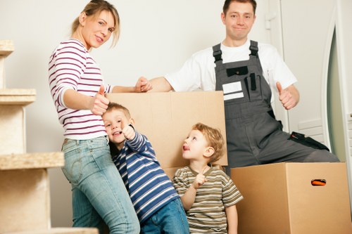Careful wrapping of household items before a move in northwest London